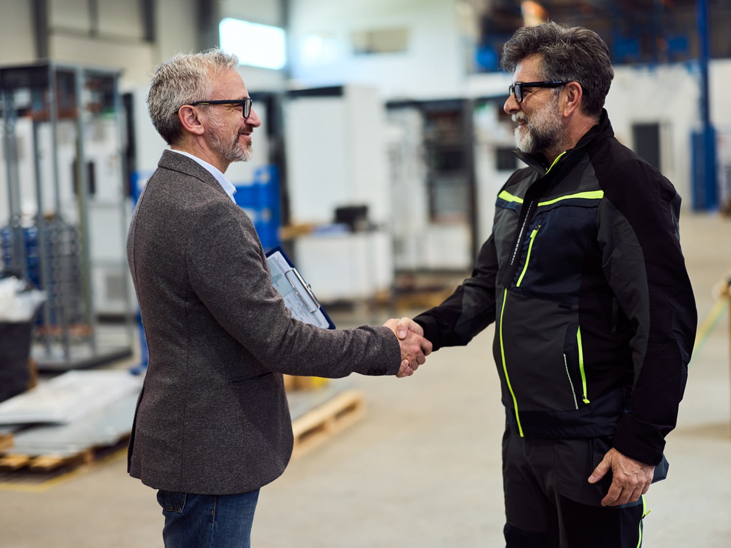 An image of 2 officials shaking hands and talking.